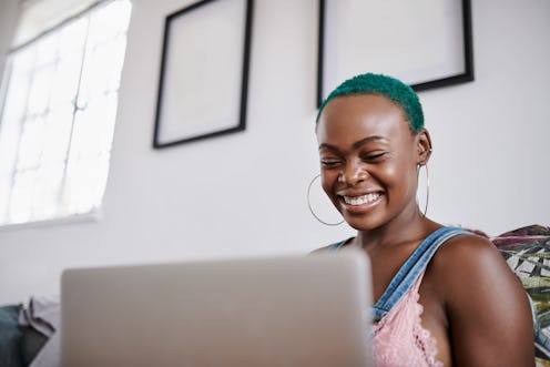 A woman with green hair copes with loneliness while working from home