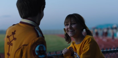 Stargirl and Leo laugh at a football game in the Disney+ movie.