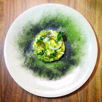 A white plate has avocado and escamoles at a restaurant in Mexico City.