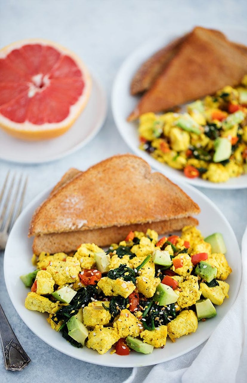 A picture of scrambled tofu with greens and avocado.