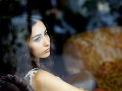 Young woman looking out window