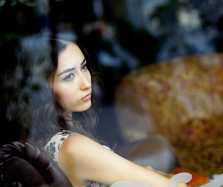 Young woman looking out window