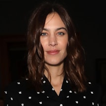Alexa Chung wearing a black blouse with white dots