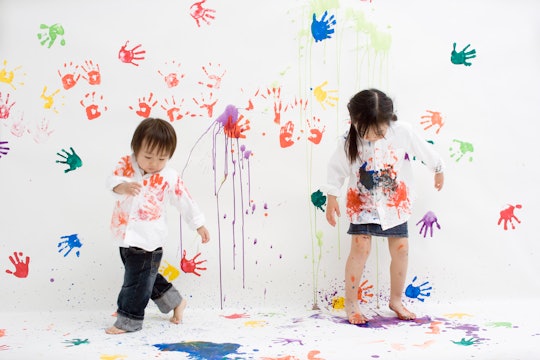 Children play with hand prints and finger paint