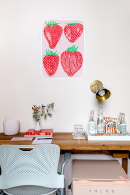Strawberries are painted on the wall near a desk in a custom mural room at Quirk Hotel in Richmond, ...