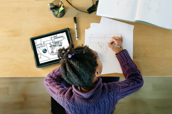 A girl does her homework at a table