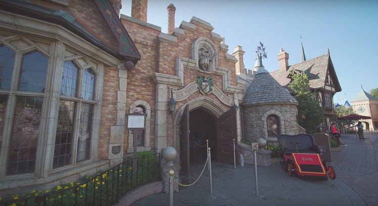 The front entrance to Mr. Toad's Wild Ride at Disneyland has a car parked out front.