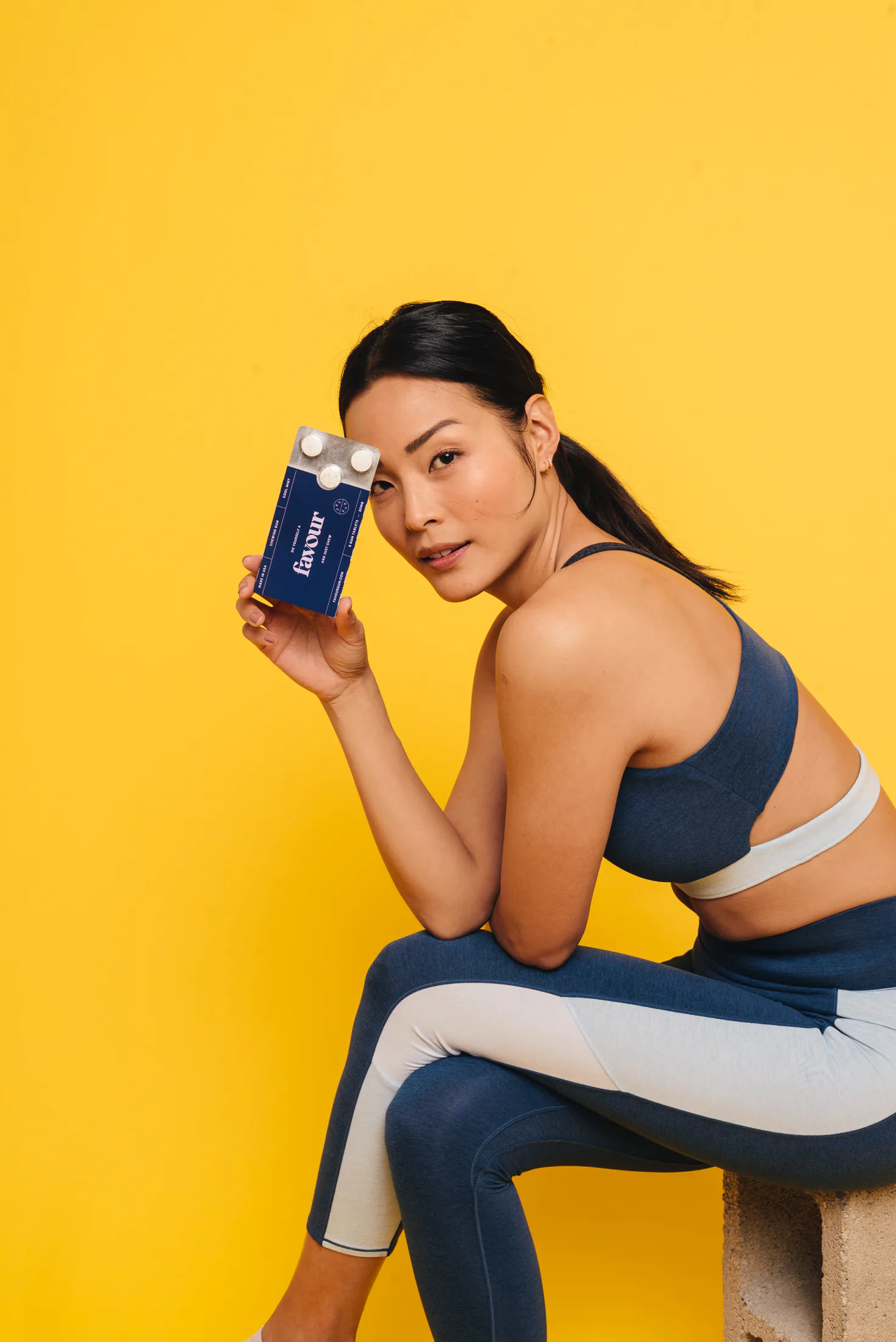 A model holding a CBD Gum Brand Favour 