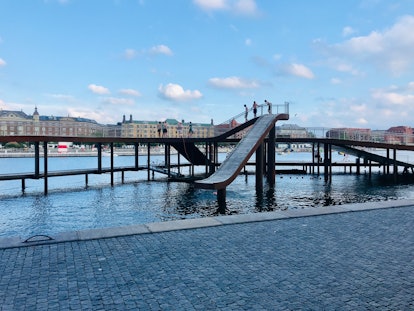 A slide goes into a canal in Copenhagen, Denmark.