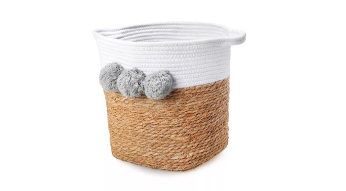 Basket with white across the top, three gray poms, and handles