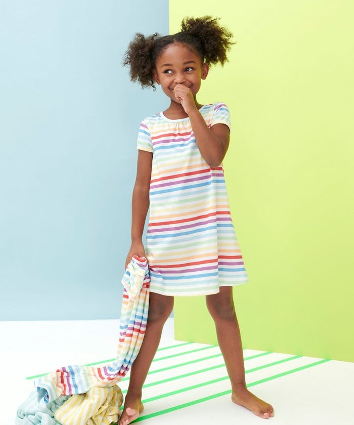 little girl wearing rainbow striped nightgown from primary