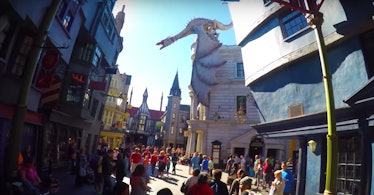 A dragon sits on top of the Harry Potter and the Escape from Gringotts Ride at the Wizarding World o...