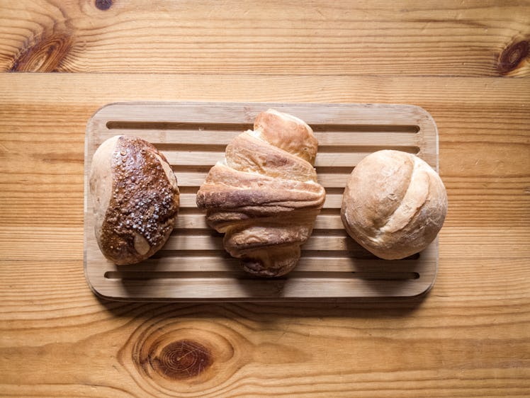 Three breads on a wooden plate