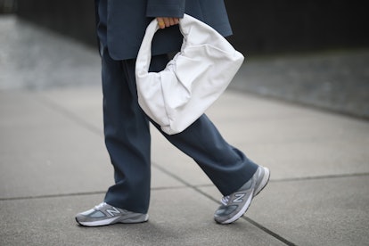 A woman walking with a white bag 