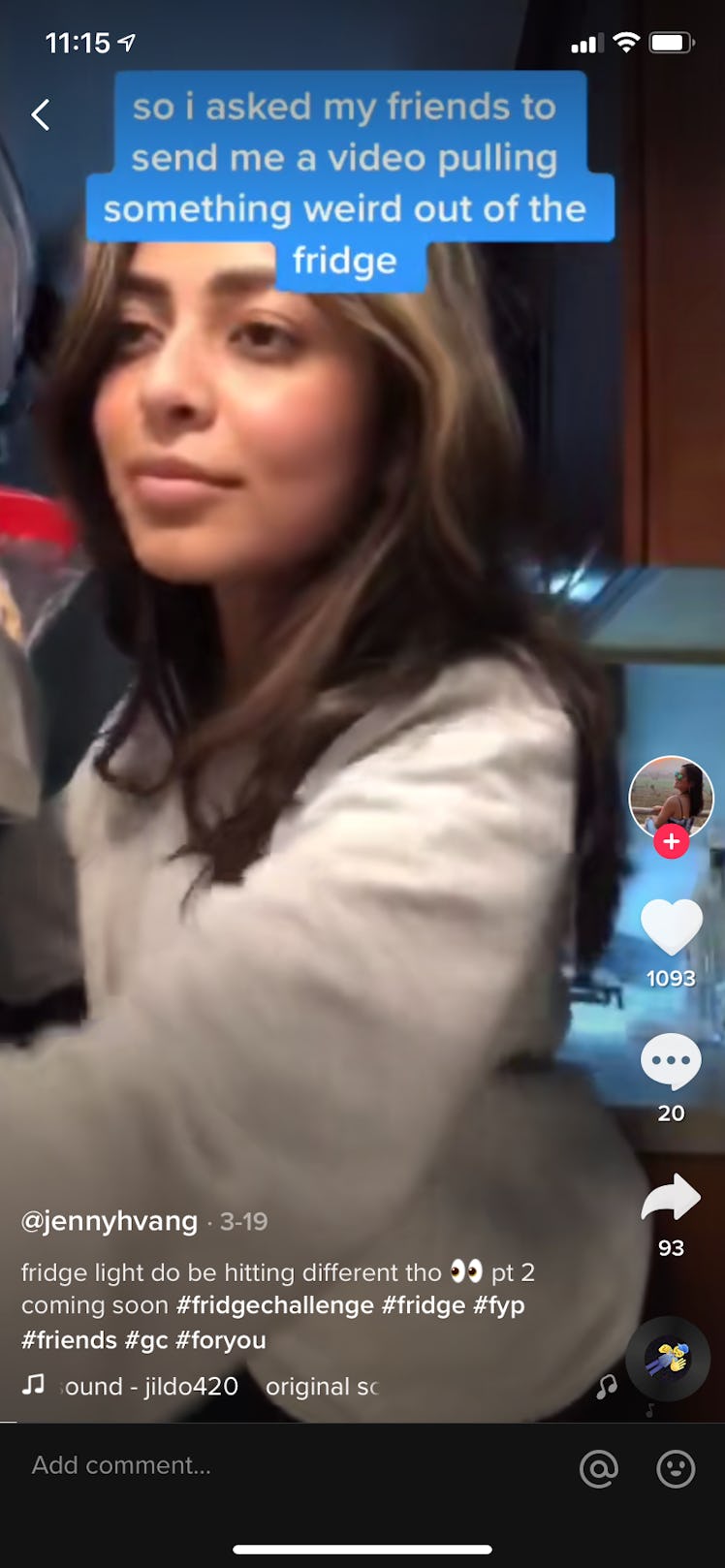 A young woman pulls a laptop out of her fridge while recording the #fridgechallenge on TikTok.