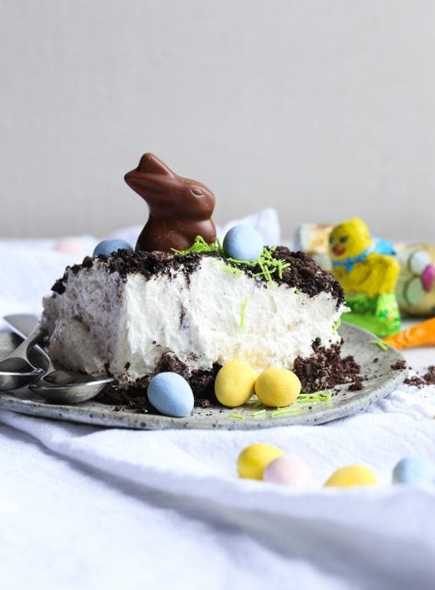 Slice of Easter bunny dirt cake topped with a chocolate bunny and surrounded by chocolate eggs