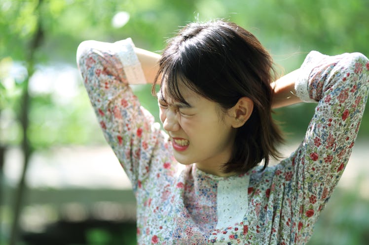 Young Asian woman gritting teeth