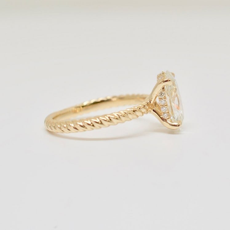 OVAL BRILLIANT IN A FRENCH PAVÉ HIDDEN HALO ROPED CABLE ENGAGEMENT RING IN YELLOW