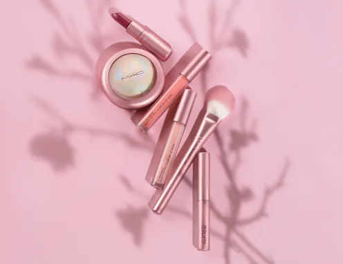 Lipstick, lip gloss, highlighter, and a makeup brush from MAC Cosmetics' new Petal Power Collection