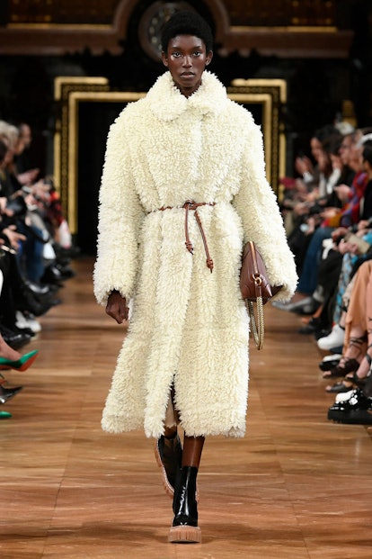 A model walking the runway in Stella McCartney's white thick teddy coat