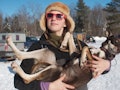 Blair Braverman, dogsled musher, holds one of her sled dogs for a photo