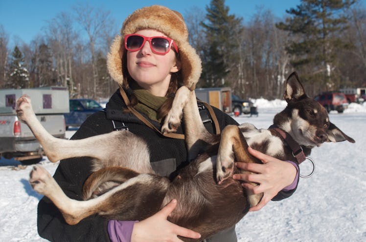 Blair Braverman, dogsled musher, holds one of her sled dogs for a photo