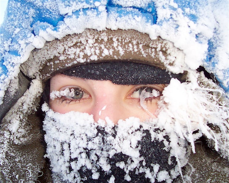 A closeup of musher Blair Braverman covered in ice