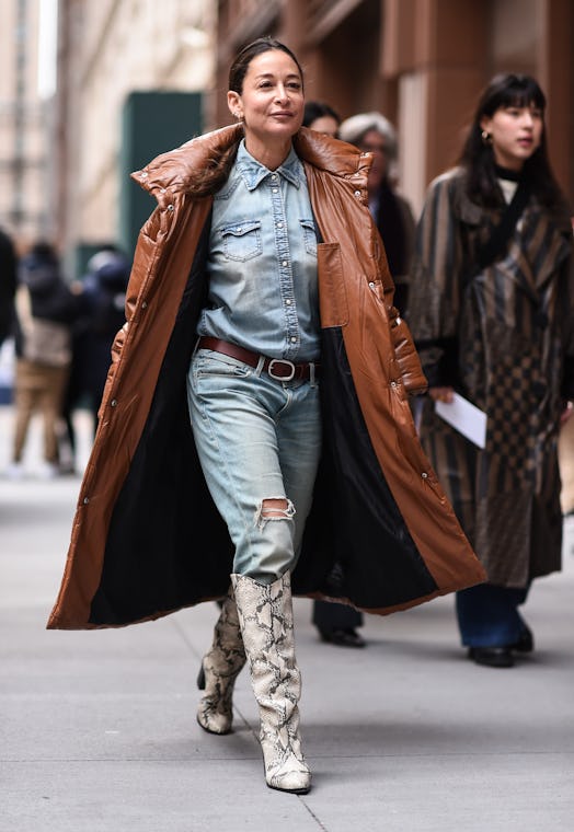 a woman wearing a Canadian Tuxedo with a snakeskin-printed boot during the spring