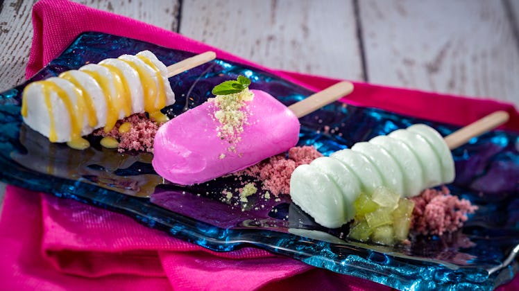 Three colorful popsicles sit on a blue glass serving platter at the 2020 Epcot International Flower ...