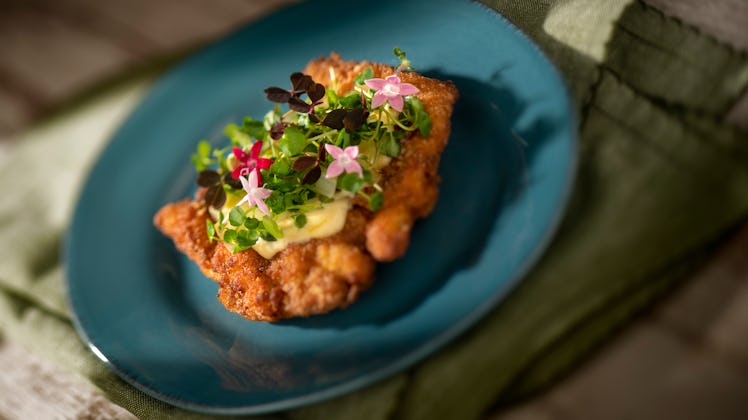 Flowers and greens decorate a citrus crispy chicken dish, which is served at the 2020 Epcot Internat...