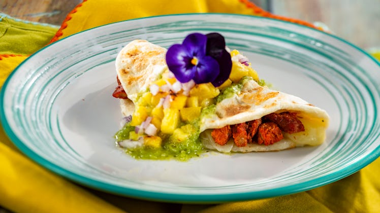 A quesadilla with flowers on top is served at the 2020 Epcot International Flower & Garden Festival ...