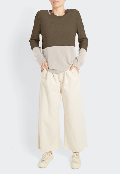 The cashmere Color Block Pull sweater in dark green and grey from Inhabit with cream pants
