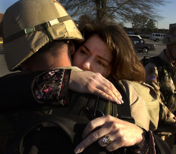 Tamara and Noel Nicolle hug each other before he deploys to Kuwait January 10, 2003 in Ft. Stewart, ...