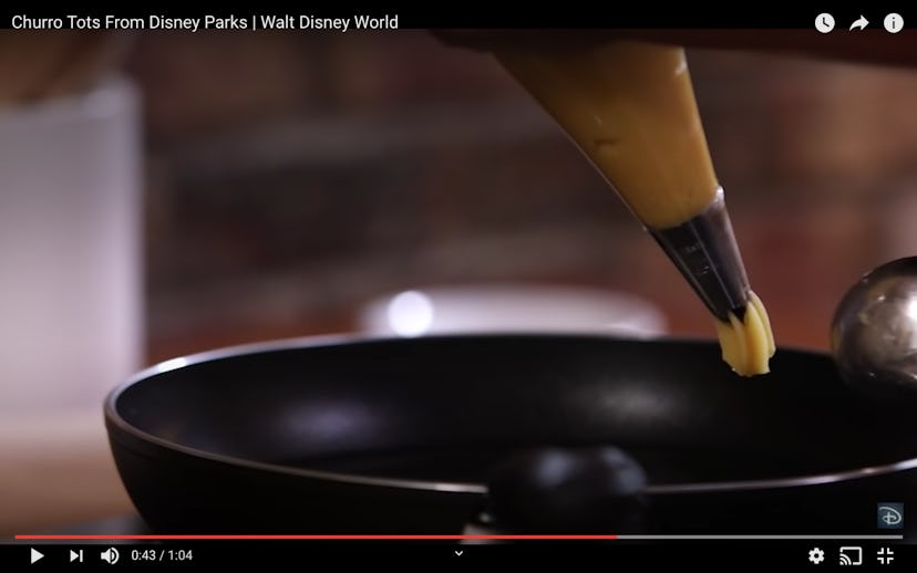 Next in the Disney churro bites recipe, pipe the churros into a saucepan. 