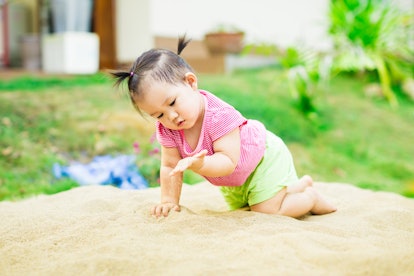 Baby sensory play in the sand