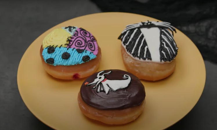 Three doughnuts decorated to look like characters from 'The Nightmare Before Christmas' are placed o...