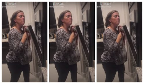 A mom creaks an oven for for a tiktok video