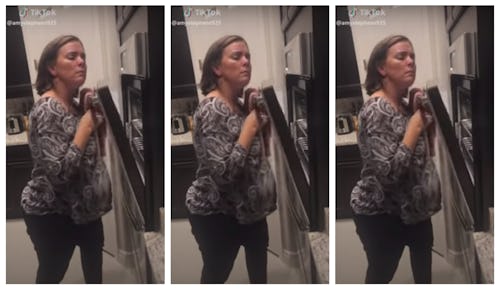 A mom creaks an oven for for a tiktok video