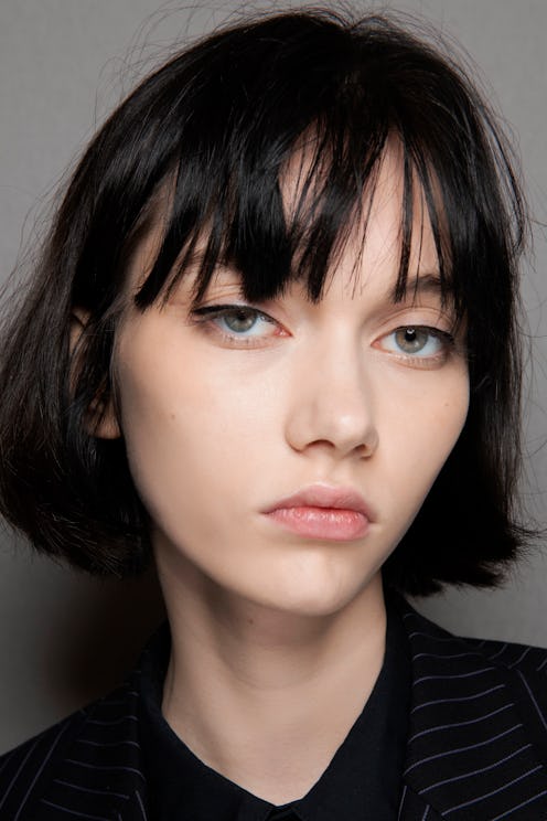 A girl with a short black hair with bangs