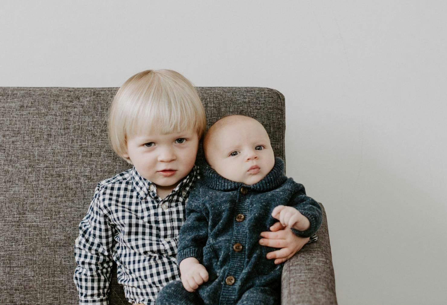 A brother holds his baby sibling