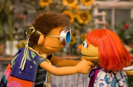 Sesame Street's Julia and her big brother Sam, dressed up as superheroes 