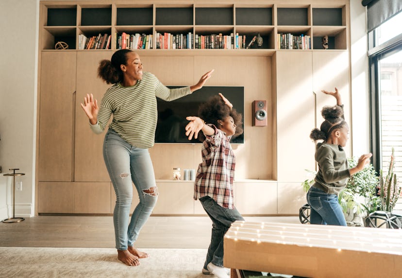 Woman dancing with kids.