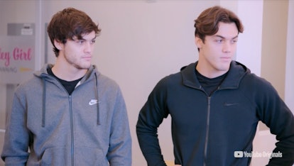 A screenshot from the video of the Dolan Twins getting spray-tan abs with Kevin Hart.