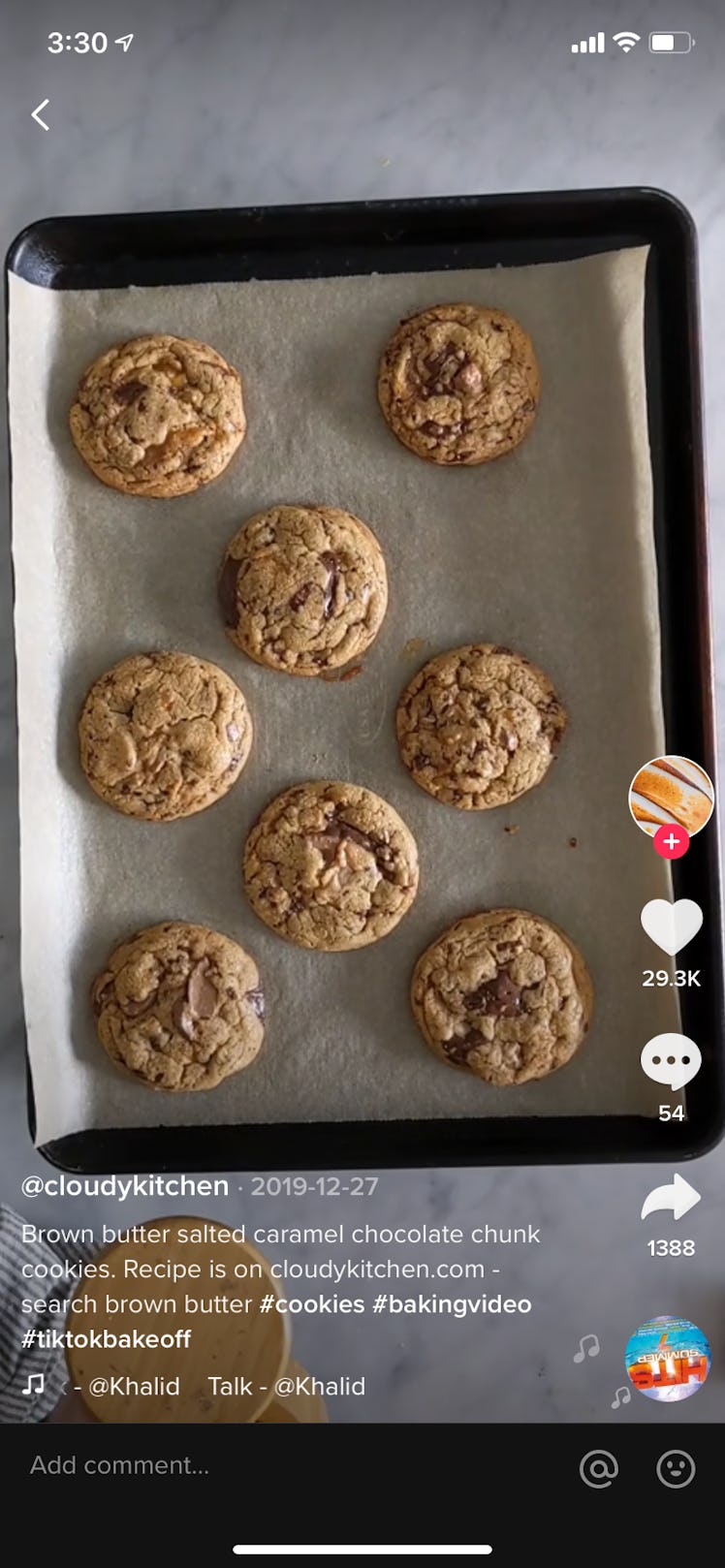 Brown butter salted caramel chocolate chunk cookies sit on a pan during a TikTok video.