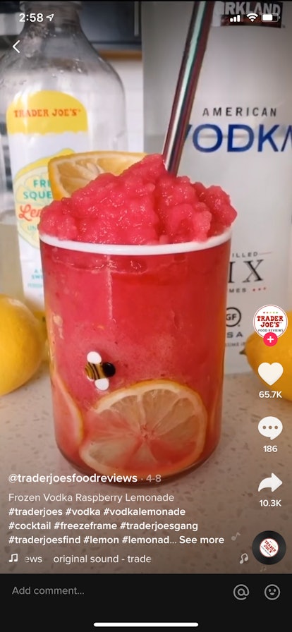A frozen vodka raspberry lemonade in a cute mason jar sits on kitchen counter for a TikTok video.