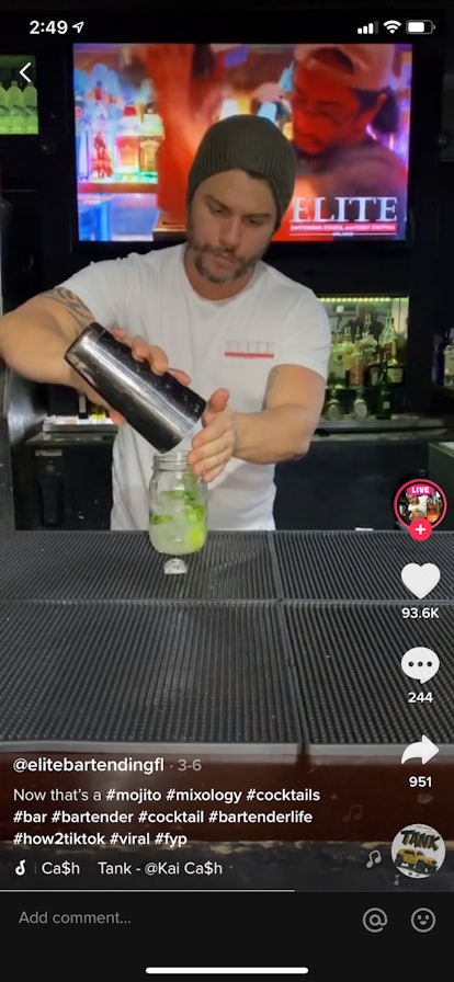 A young bartender brews a fresh mojito in a bar for TikTok.
