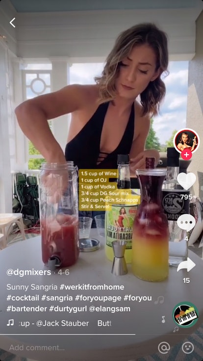 A woman in a swimsuit mixes up some sangria on her porch at home. 