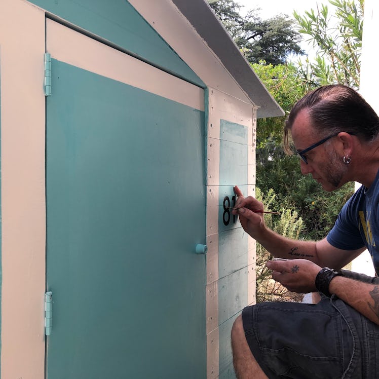 Gano painting the house.