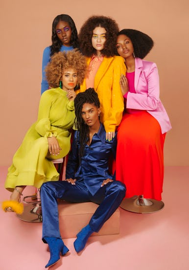 Five models dressed in navy blue, light blue, orange, pink and light green posing for NYLON's black ...