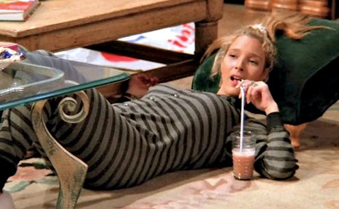 Lisa Kudrow, in Friends, having a drink while lying down the floor